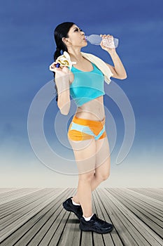 Fitness woman take a rest and drink water