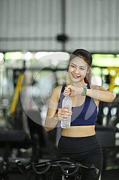 Fitness woman taking a break and drinking water after workout.