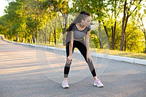 Fitness woman tired jogger breathing after run marathon in park.