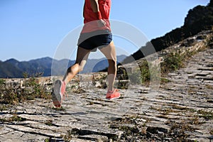 Fitness woman trail runner running on top of mountain