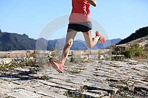 Fitness woman trail runner running on top of mountain