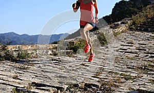 Fitness woman trail runner running on top of mountain