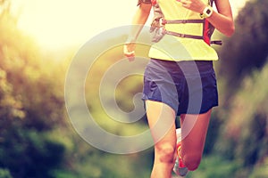 Fitness woman trail runner running on trail