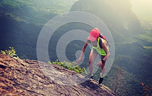fitness woman trail runner running up to mountain top