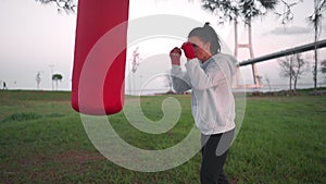 Fitness woman training boxing with punching bag