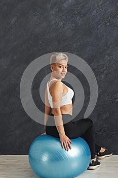 Fitness woman training with fitness ball indoors