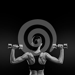 Fitness woman in training muscles of the back with dumbbells