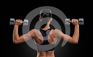 Fitness woman in training muscles of the back with dumbbells photo