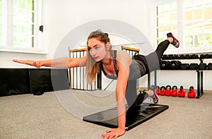 Fitness woman in training working out on a yoga mat