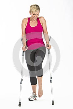 Fitness woman walking with crutches