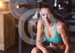 Fitness Woman and weights with flare in a gym