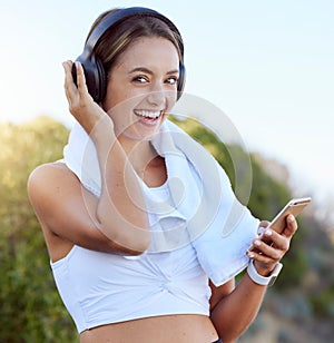 Fitness woman, wireless headphones and music streaming app on phone while outside with a smile during exercise, workout