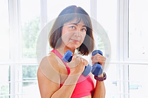Fitness woman working out with dumbbells