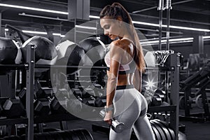 Fitness woman working out in gym. Athletic girl training