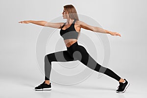 Fitness woman yoga training doing lunges exercises for leg. Active girl doing front forward one leg step lunge