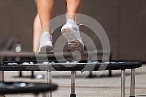 Fitness women jumping on small trampolines