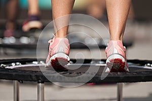 Fitness women jumping on small trampolines