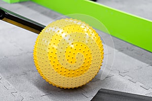 Fitness on wooden floor. Sports balls. Yoga ball in fitness room.Exercise yellow color ball in fitness, gym equipment and fitness