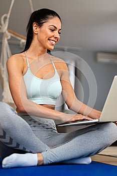 Happy fit sporty woman exercising to stay healthy. Fitness workout at home, watching videos online photo