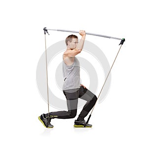 Fitness, workout and resistance band with a young man in studio isolated on a white background for health. Gym, exercise