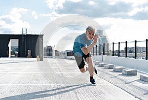 Fitness, workout, sport, lifestyle concept. Middle-aged man running in the city