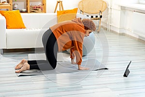 Fitness Workout training. Young healthy fit african girl doing sports exercise on yoga mat on floor at home. Athletic