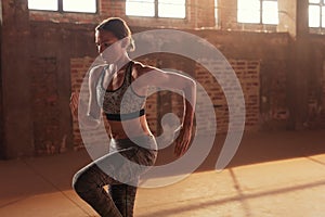 Fitness workout. Woman running on spot, doing cardio exercise photo