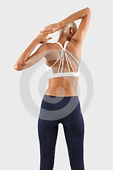 Fitness workout, woman stretching arms and back, african latin american female athlete in sportswear, Sportswoman do training