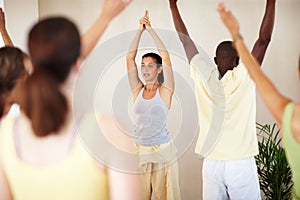 Fitness, yoga class and group with personal trainer for stretching, exercise and workout in studio. Pilates, health club