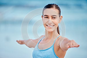 Fitness, yoga and face of woman by beach with warrior pose for wellness, healthy body and energy. Sports, nature and