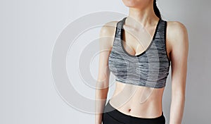 Fitness and Yoga Healthy Lifestyle Concept. Sporty Young Woman Wearing Black and Gray Sport Bra with Muscular Body and Strong Six