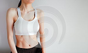 Fitness and Yoga Healthy Lifestyle Concept. Young Woman Wearing White Sport Bra and Pants with Muscular Body and Strong Six Pack