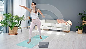 Fitness, yoga or pregnant woman in online class stretching body for balance exercise or workout at home. Pregnancy