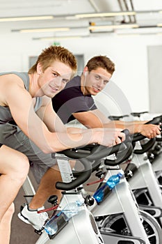 Fitness young man on gym bike spinning