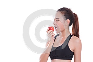 Fitness young woman eating apple.