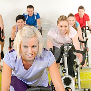 Fitness young woman on gym bike spinning