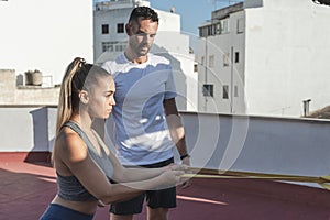 Fitness young woman and her personal trainer