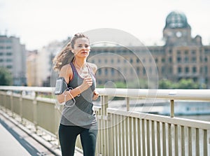 Fitness young woman jogging in the city
