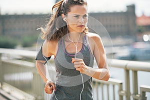 Fitness young woman jogging in the city