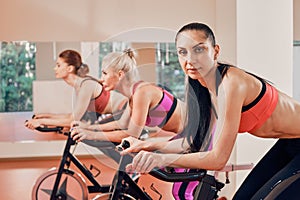 Fitness young woman portrait on exercise bikes