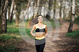 Fitness young woman running in spring park