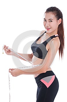 Fitness young woman taking measurements of her body.
