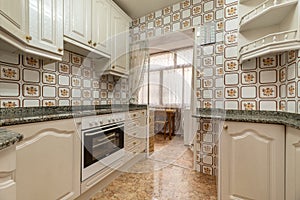 A fitted kitchen with granite worktops photo