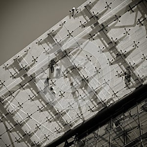 Fitters on a glass roof on a construction site photo