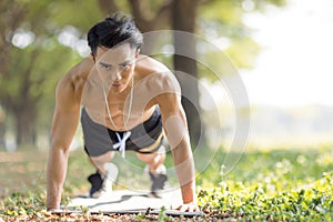 Fittness asian Young man doing exercises in the park