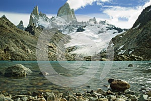 Fitz roy peaks with clear blue glacial lake from low perspective