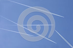 Five aircrafts in the ski make a graphic sign with condensation trails with copy space for your text