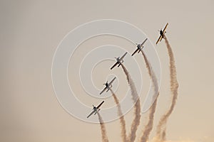 Five airplanes in formation on airshow. Aerobatic team performs flight at air show
