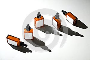 Five amber bottles with droppers are neatly positioned on a light surface, creating a visually appealing arrangement photo