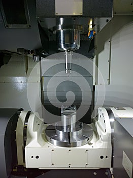 The five-axis Computer Numerical Control CNC machine waiting for stock change